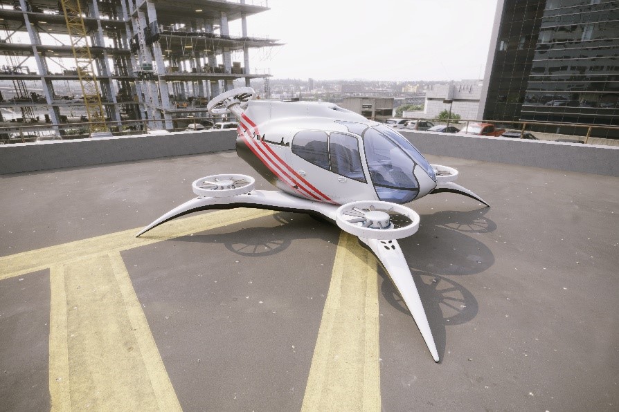 vertical flight aircraft on helipad with buildings in background